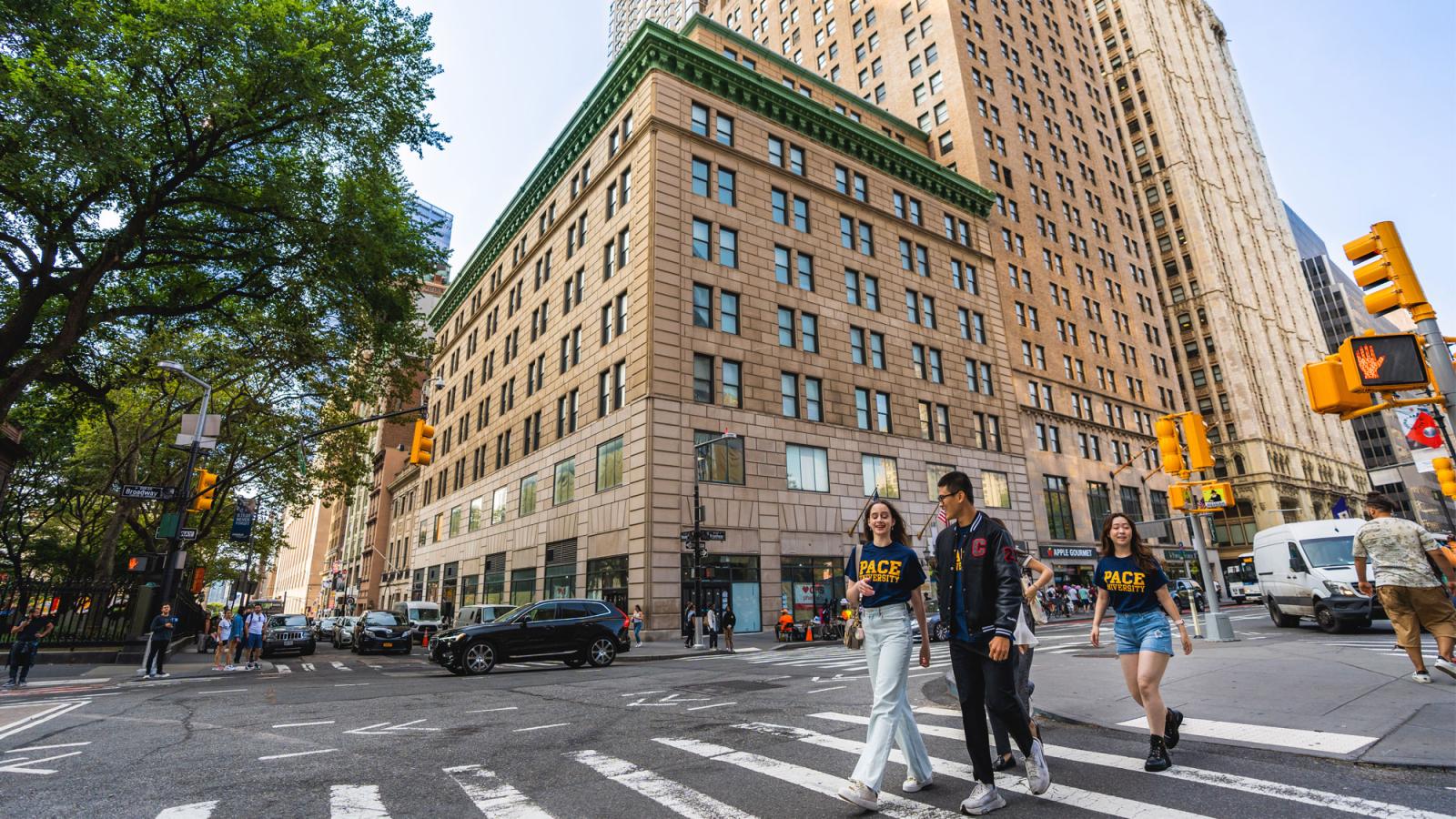 People in Pace University t-shirts walking in NYC.