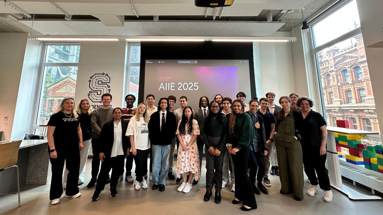The 2025 AI Internship Experience interns, faculty, and staff posing for a photo in the Seidenberg Design Factory space.