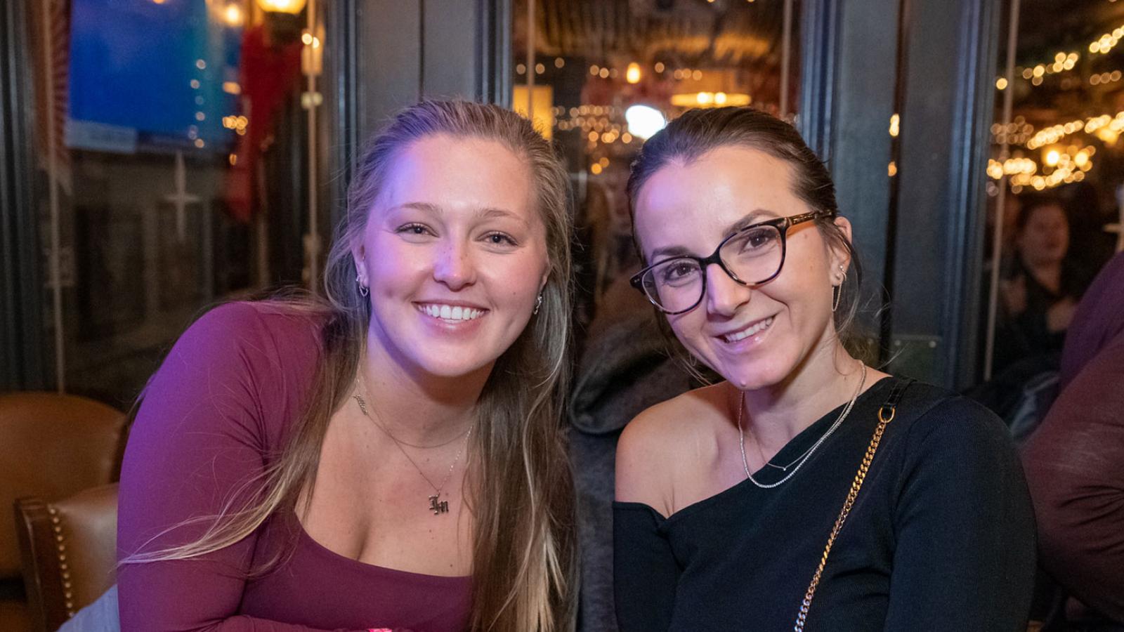 Two Pace University alumni smiling at the camera.