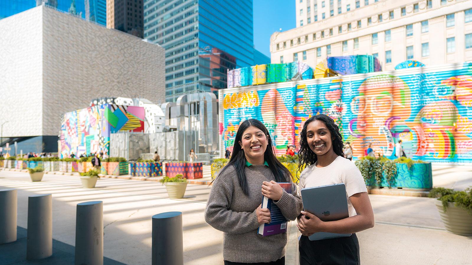 Two Pace University students posing for a photo in lower Manhattan.