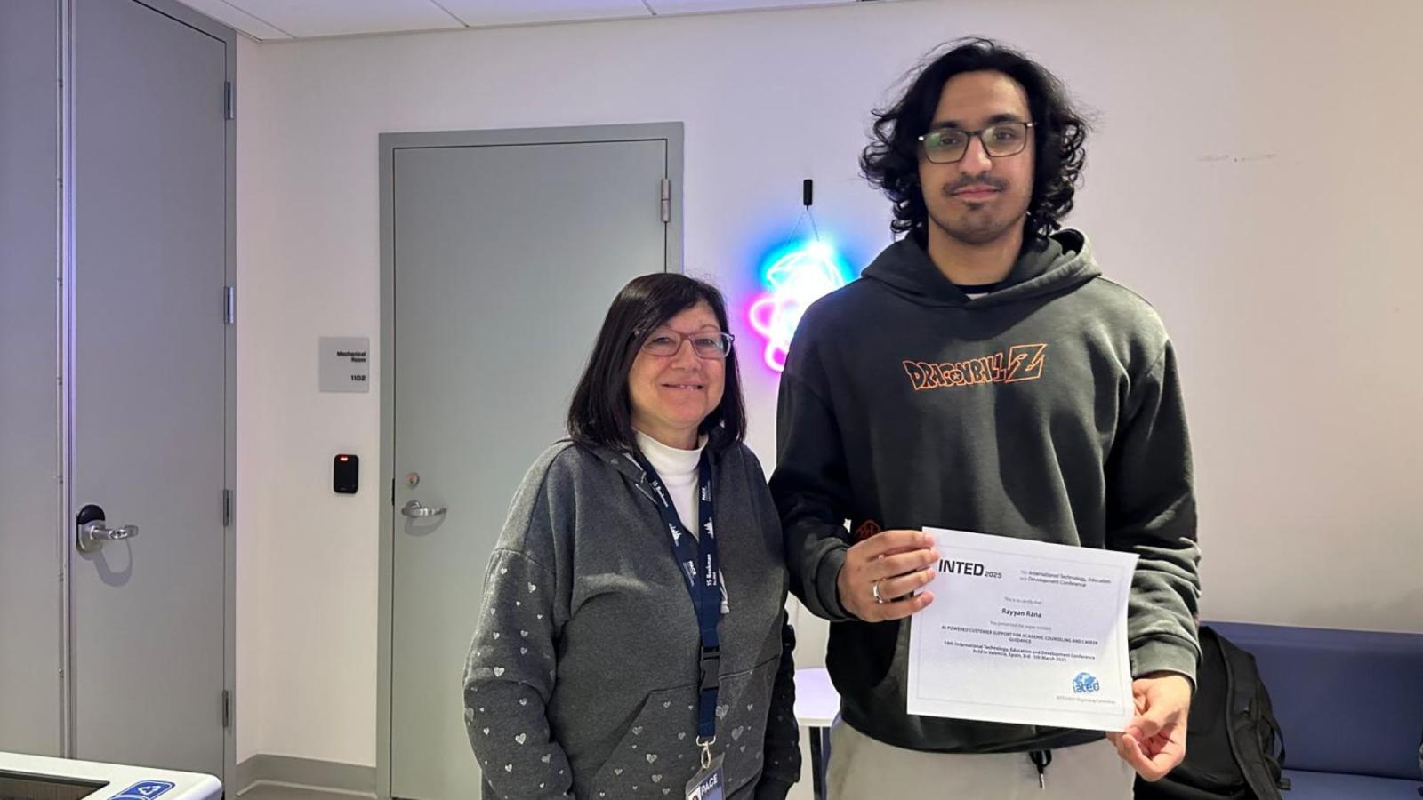 Seidenberg professor Mary Tedeschi posing for a photo with a Seidenberg student who is holding their diploma from the INTED 2025 conference.