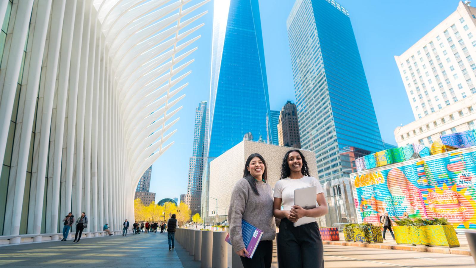 Two Pace students posing near the Oculus.