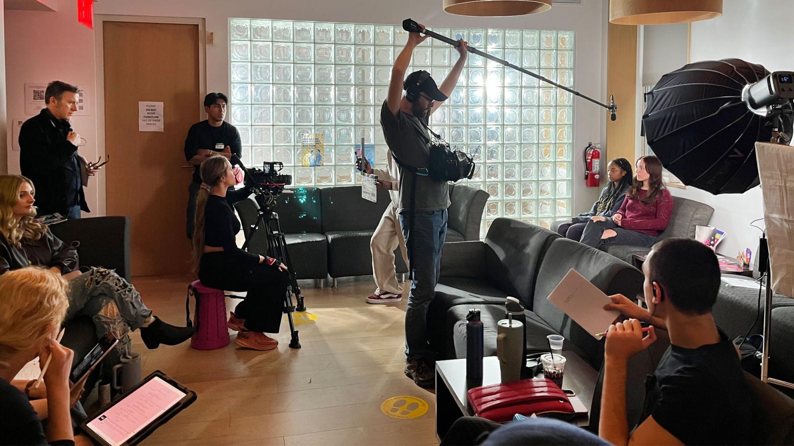 Pace University students filming in a room.