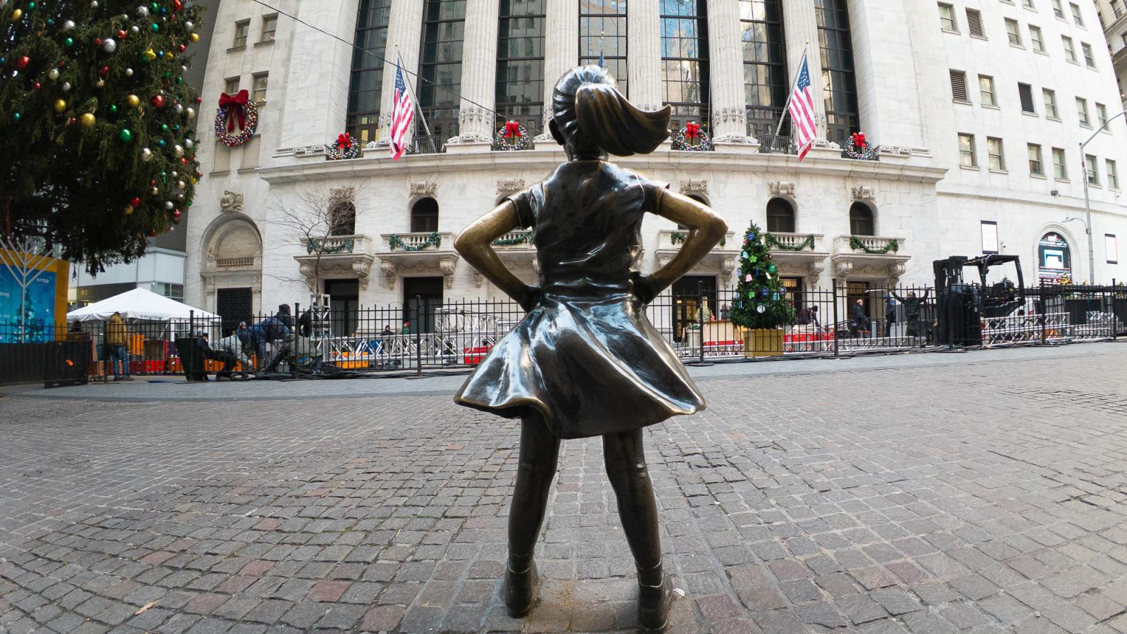 Bronze Fearless Girl statue facing the New York Stock Exchange on Wall Street in Manhattan