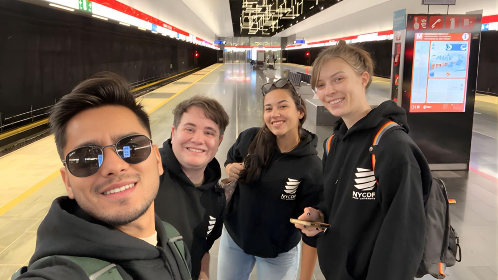 Pace Seidenberg team of students from the NYC Design Factory posing for a photo on a subway platform in Finland.