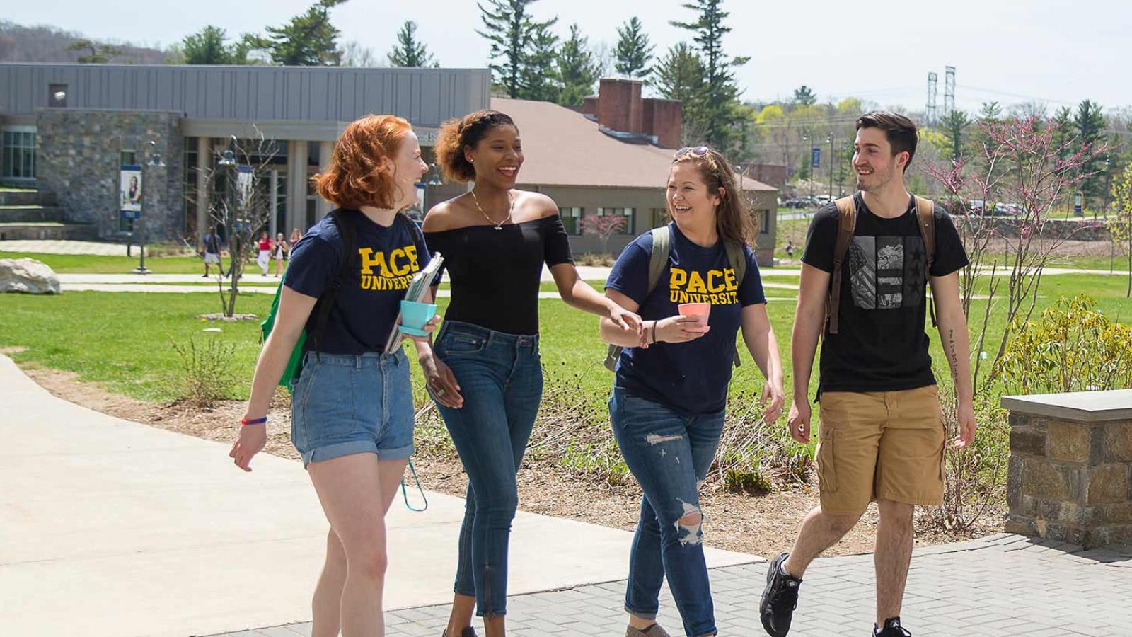 Group of students walking toward a residence hall on the Westchester campus.