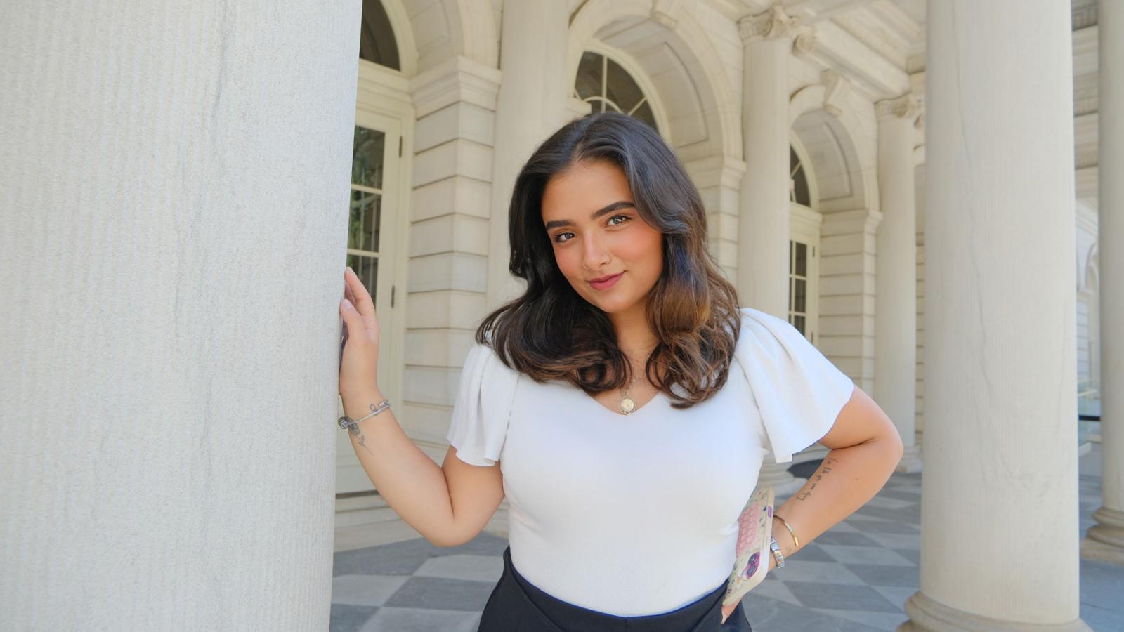 Alexis Pickering '26 posing on the front steps of NYC's City Hall.