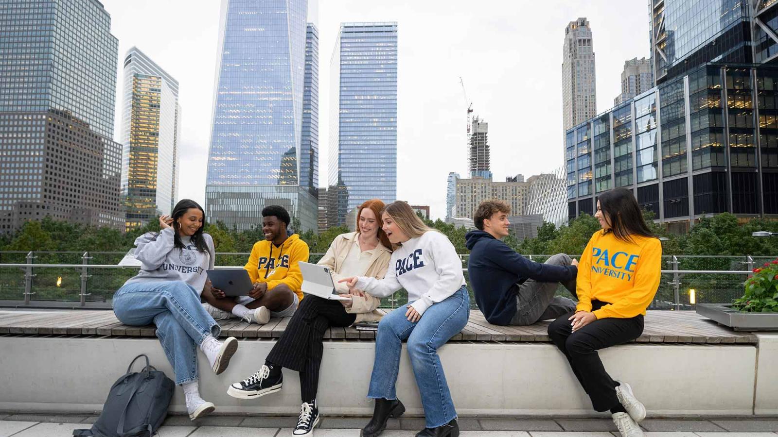 Students chatting with each other in Lower Manhattan with skyscrapers in background