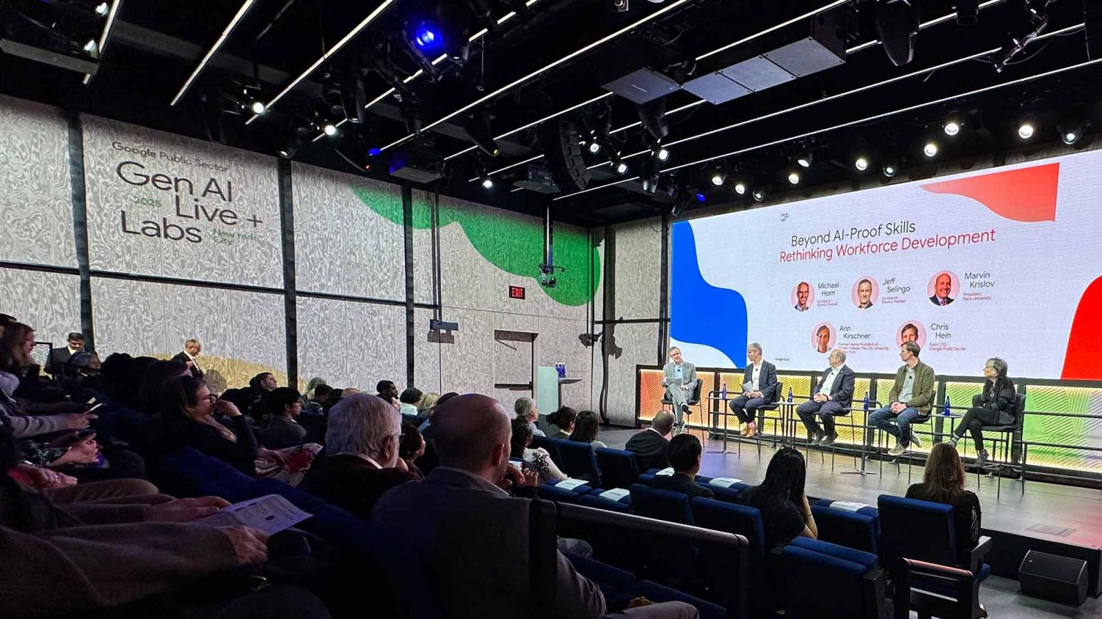 Marvin Krislov on stage with panelists in front of an audience.