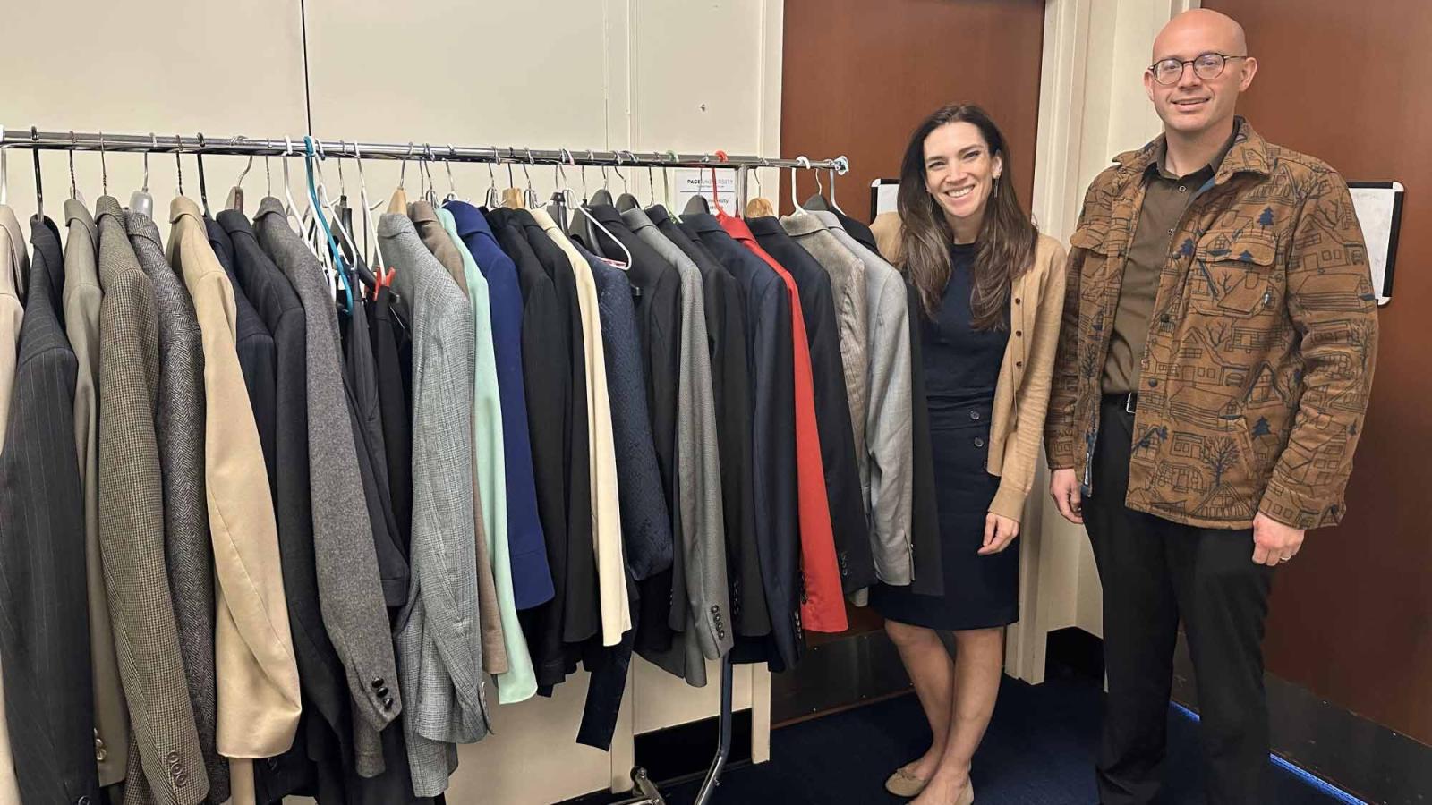 Elisabeth Haub School of Law at Pace University alumni Kristen Motel '15 and Maximillian Mahalek ’19 standing in front of donated business suits
