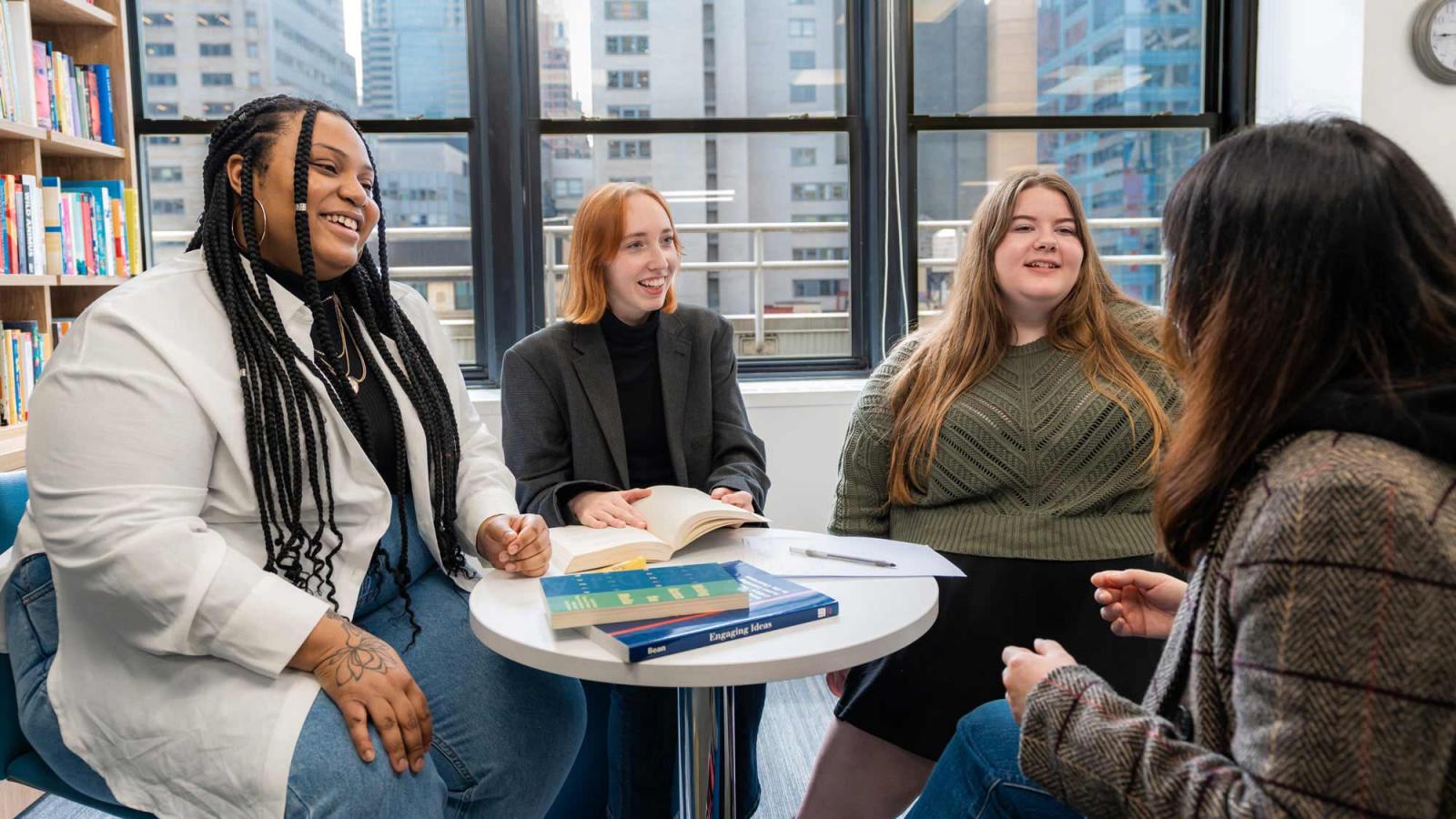 Pace University students talking to each other in a lounge.