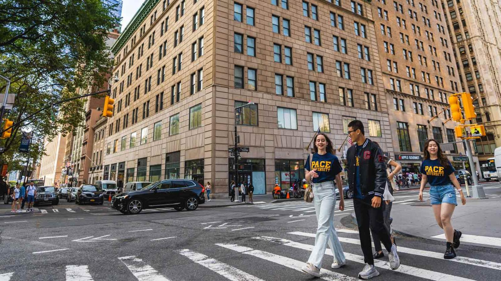 People in Pace University t-shirts walking in NYC.