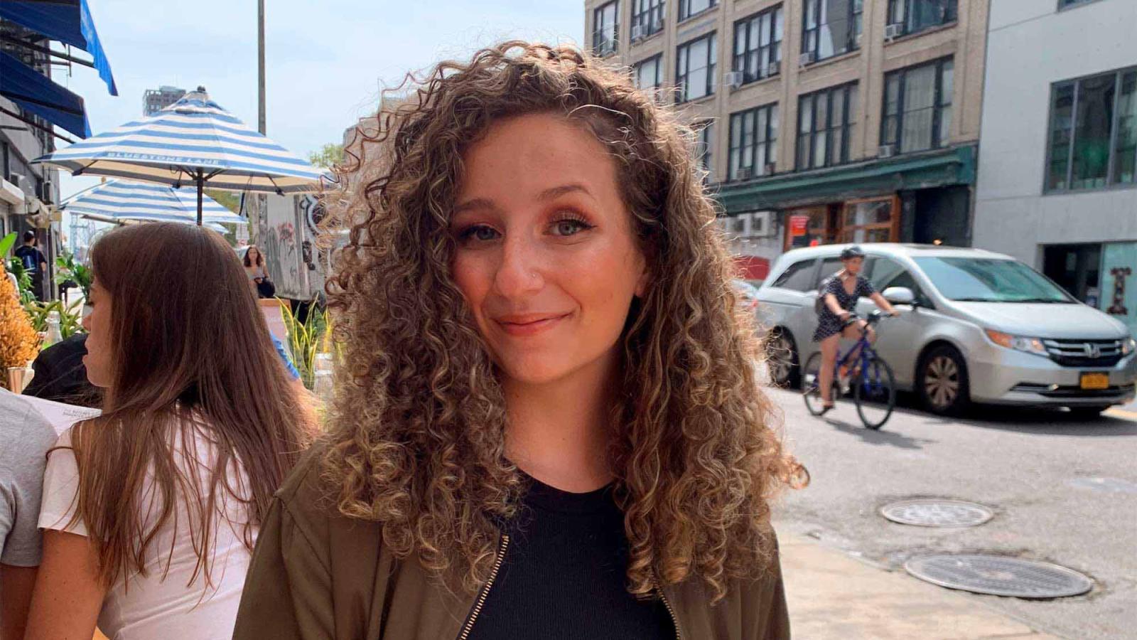 woman with curly hair in the city