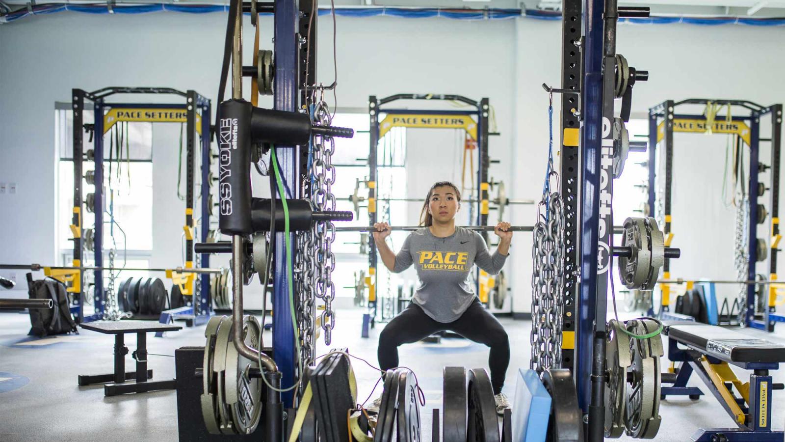 woman in gym lifting weights