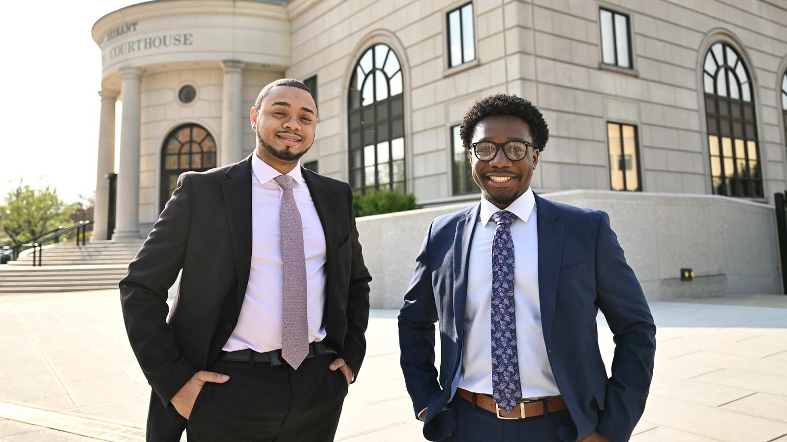 Two Pace Haub Law students outside a courthouse in professional attire