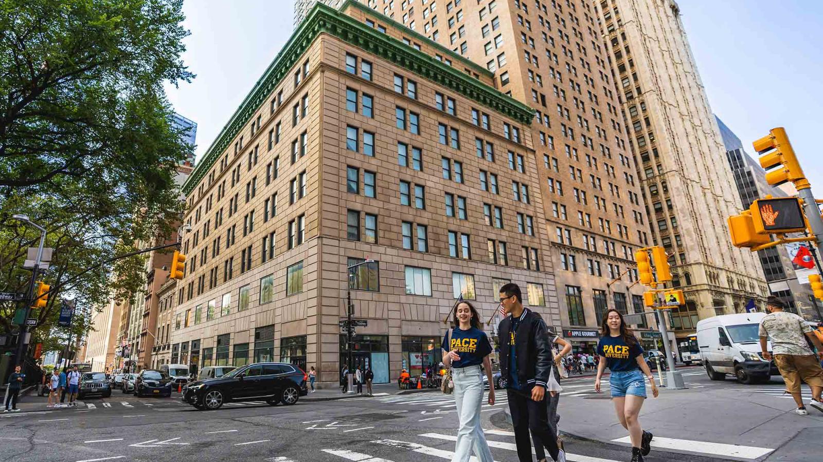 two Pace University students walking in front of One Pace Plaza in Lower Manhattan