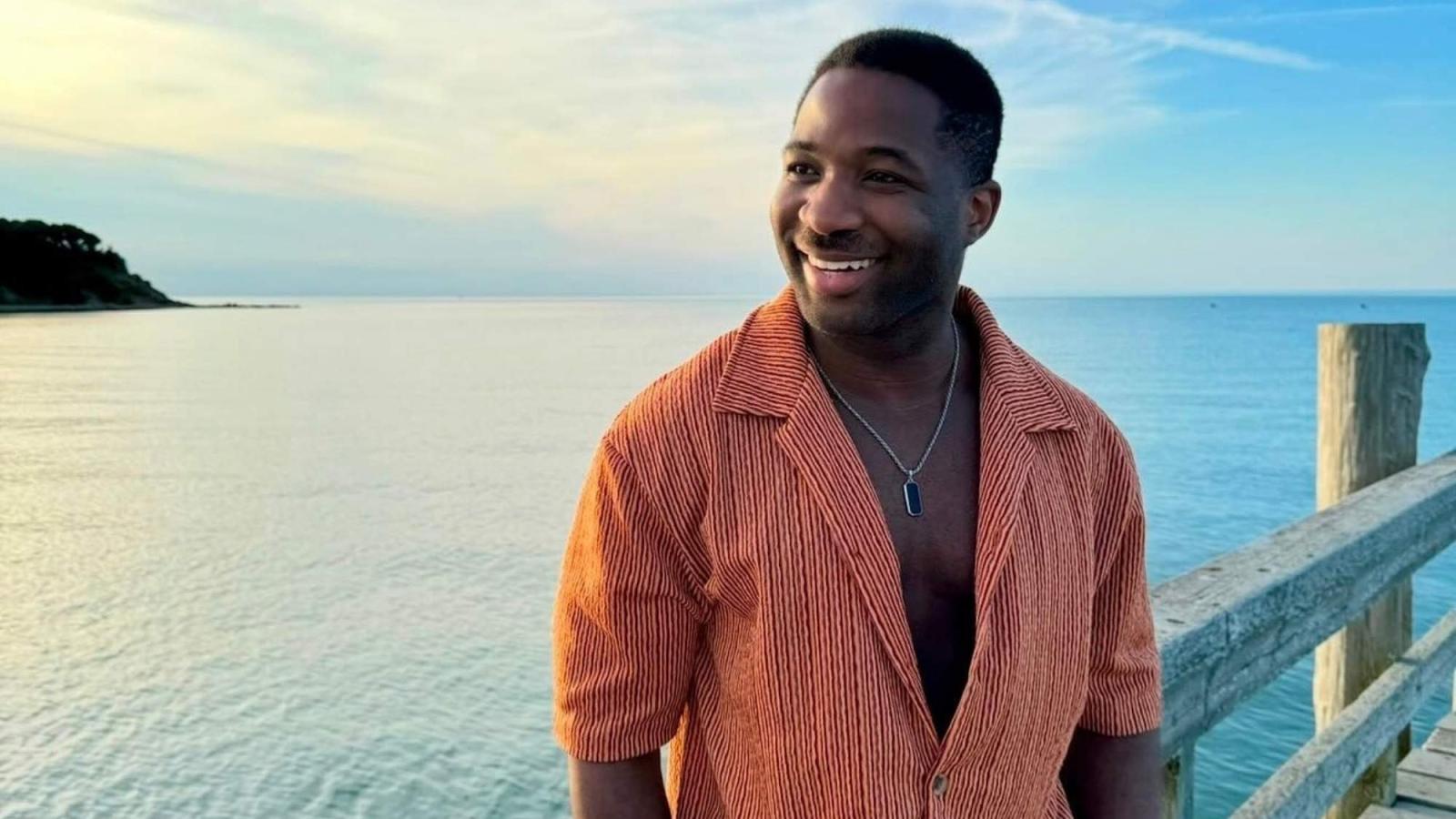 Seidenberg graduate Onye Ohiaeri on a pier overlooking the ocean