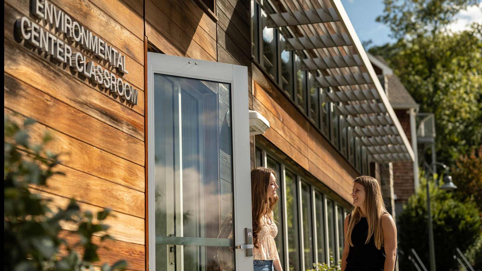 Two Pace University students exiting the Environmental Center Classroom on the Westchester campus.