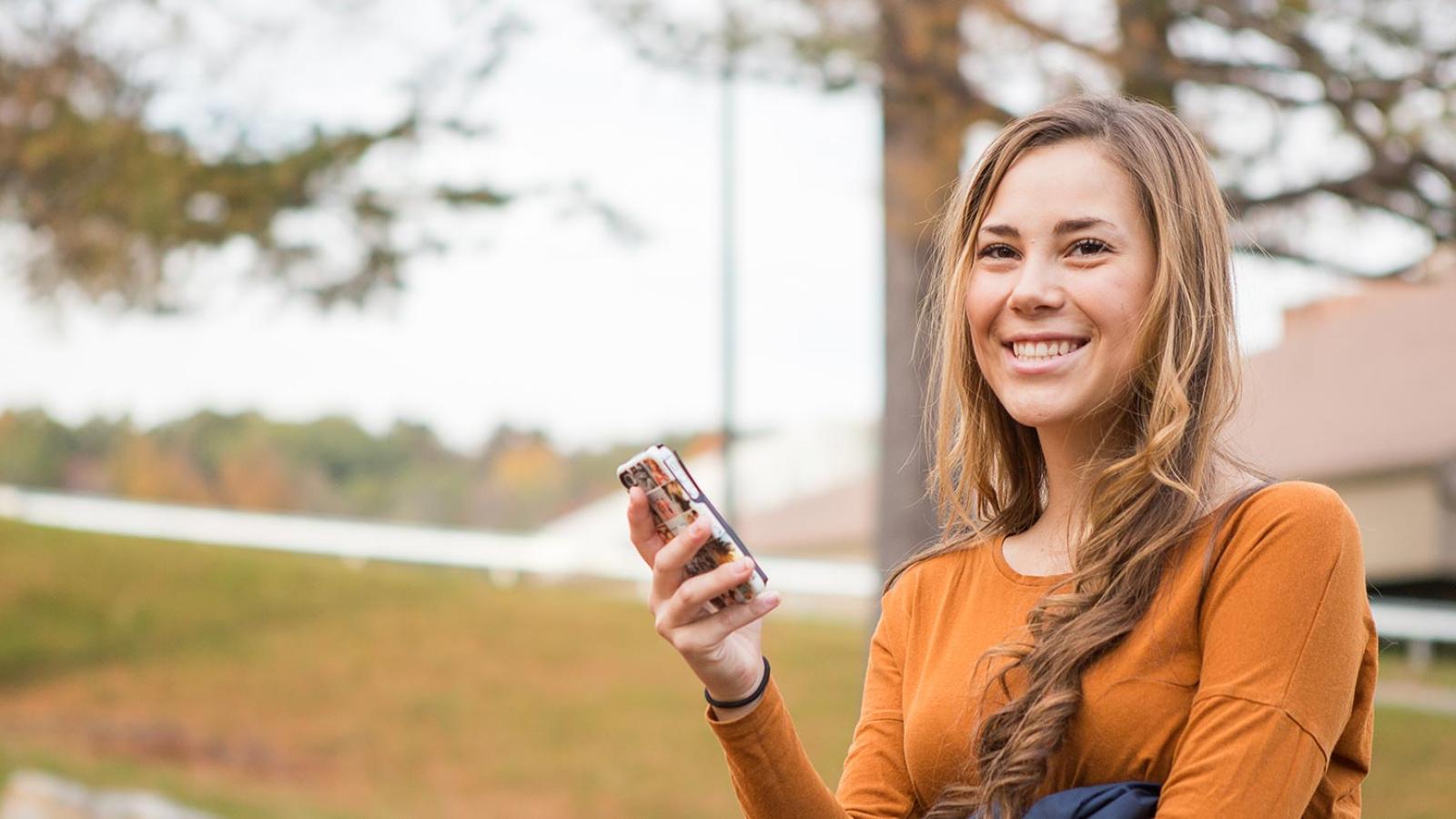 Pace University student looking at her cell phone.
