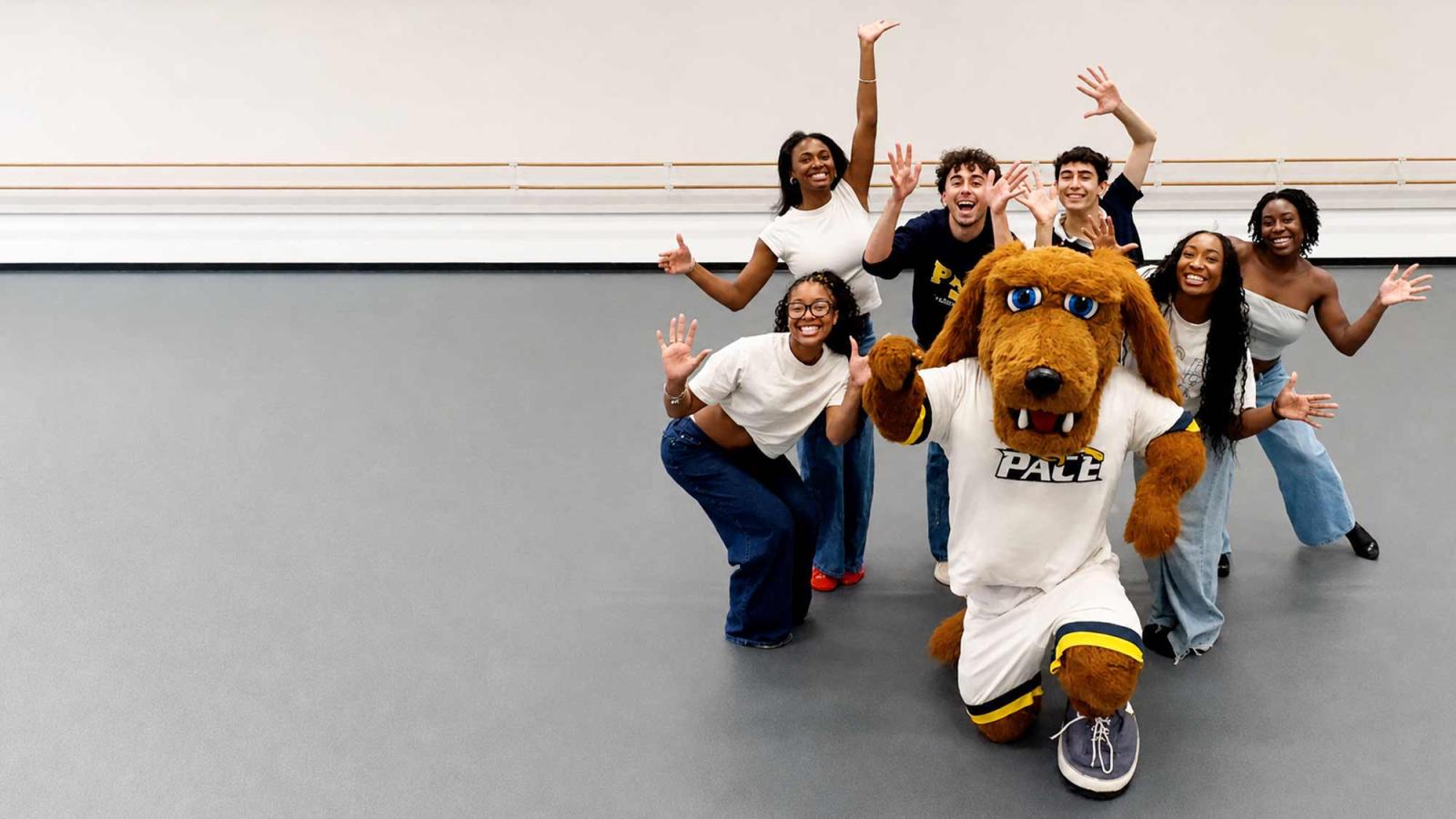 A group of commercial dance students in a new dance studio with Pace mascot, T-Bone.
