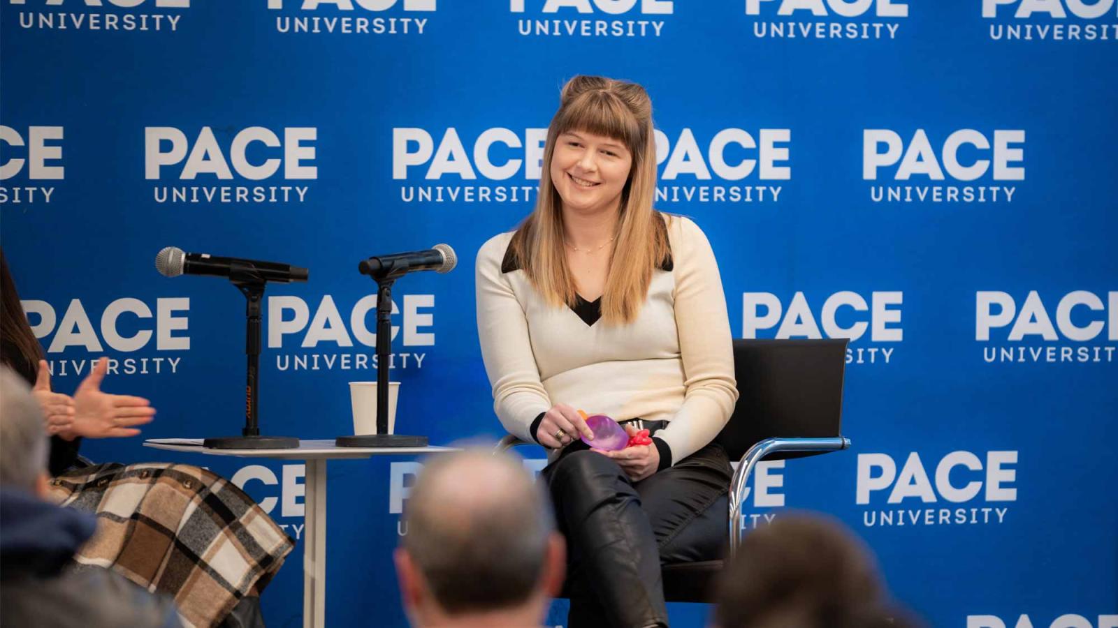 Kaelynn Partlow speaking to an audience at Pace.