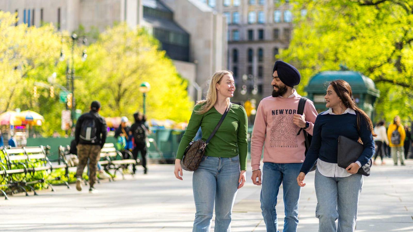 Three Pace University graduate students walking in NYC.