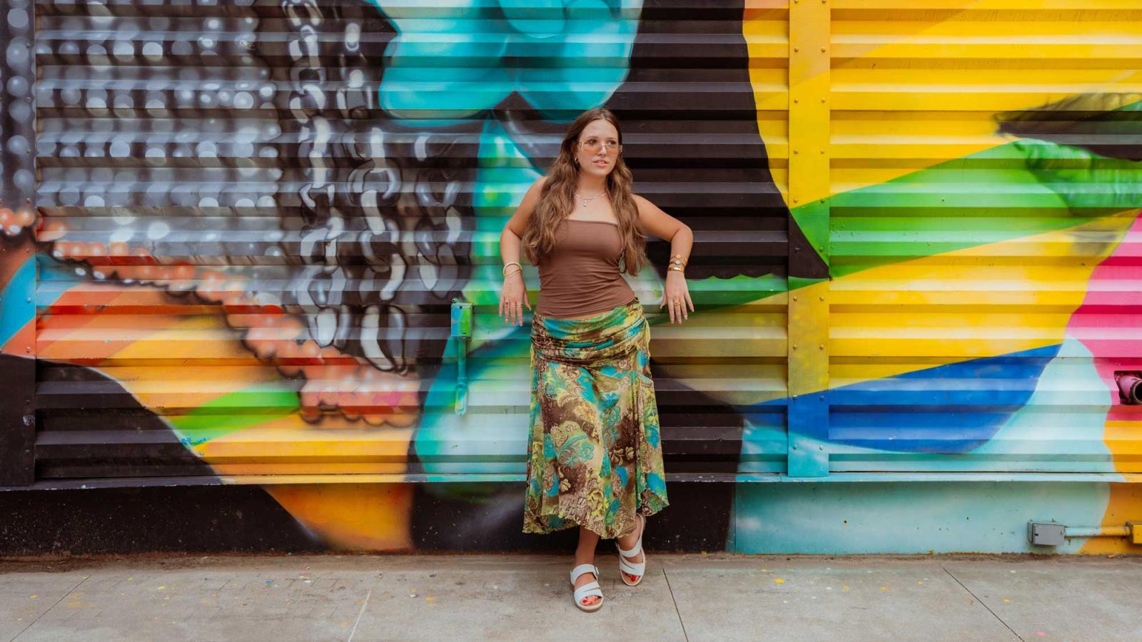 Pace University student standing in the middle of NYC, looking at the camera.
