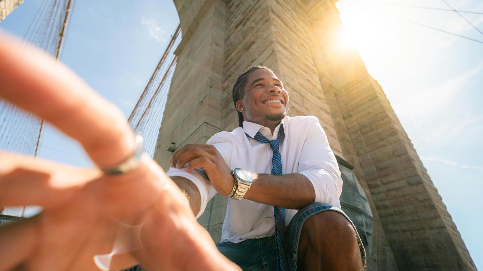 Pace University student taking a selfie on the Brooklyn Bridge.