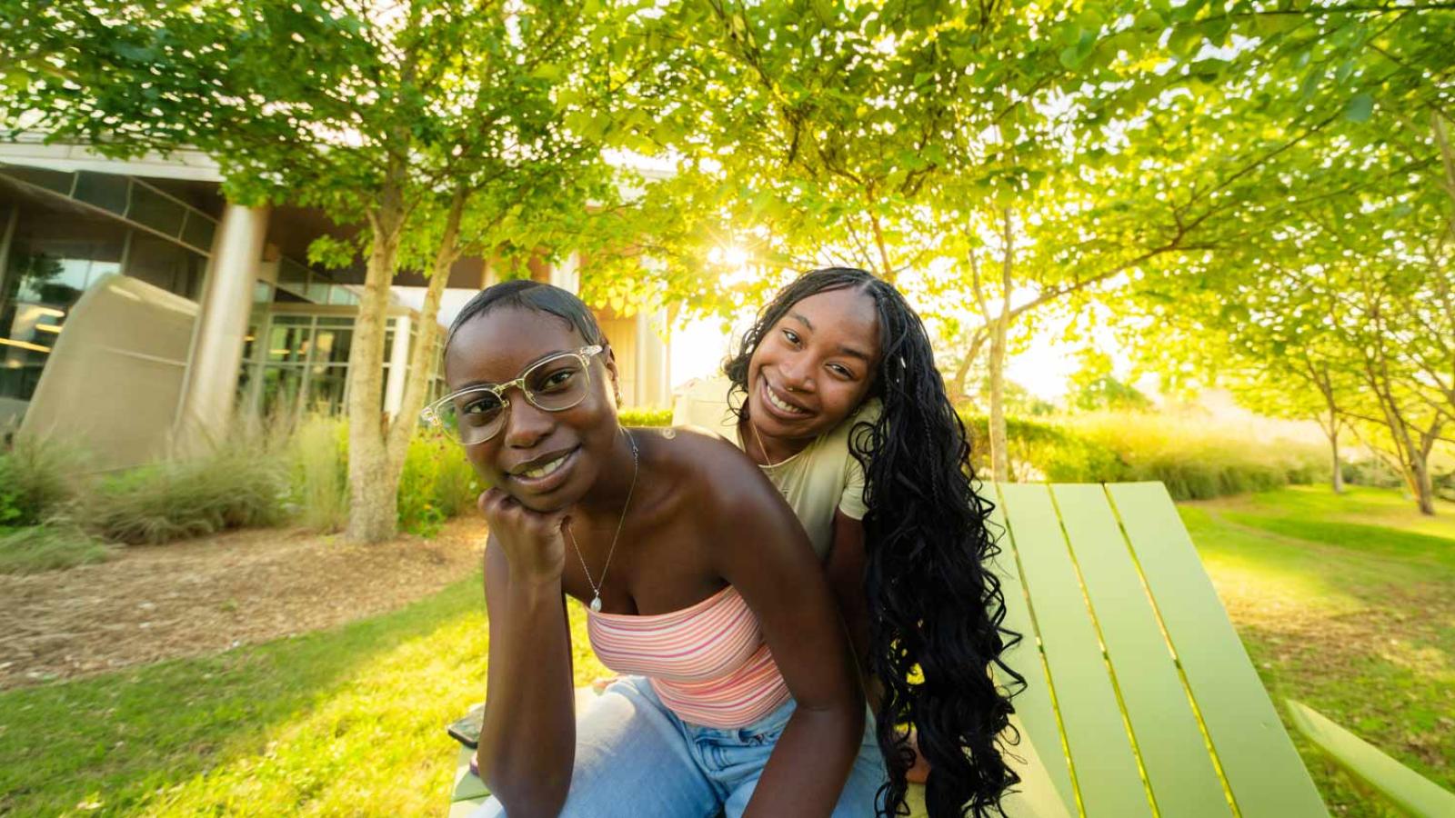 Two Pace students smiling at the camera on Pace University's Weschester campus.