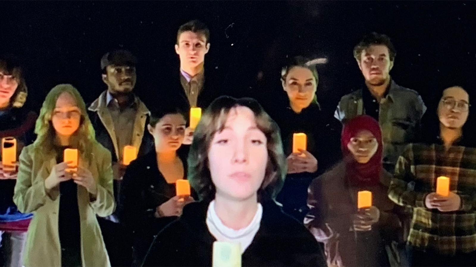 screenshot of many people holding candles