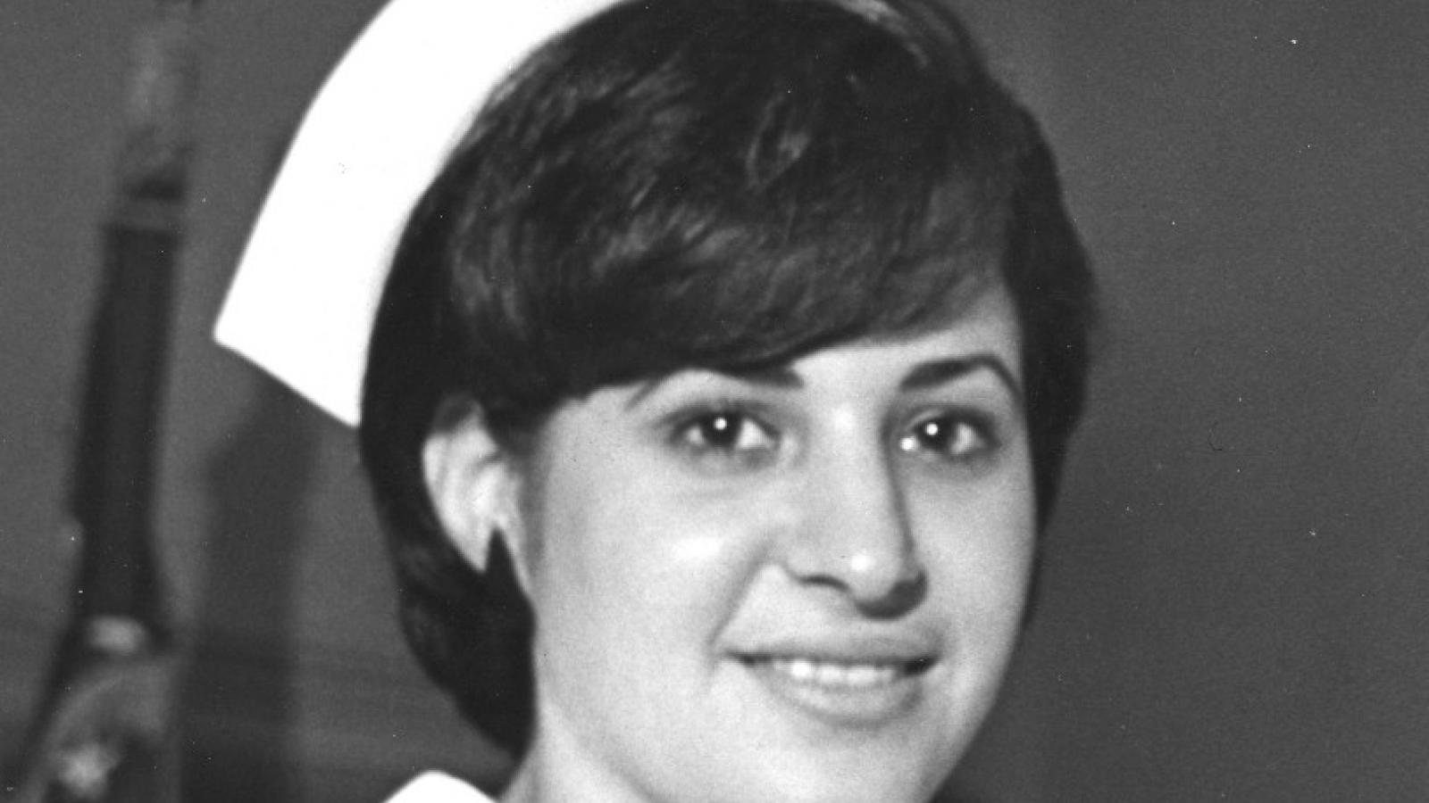 black and white photo of a woman in a vintage nurse uniform