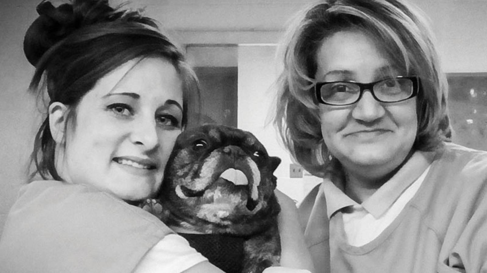two women and a pug