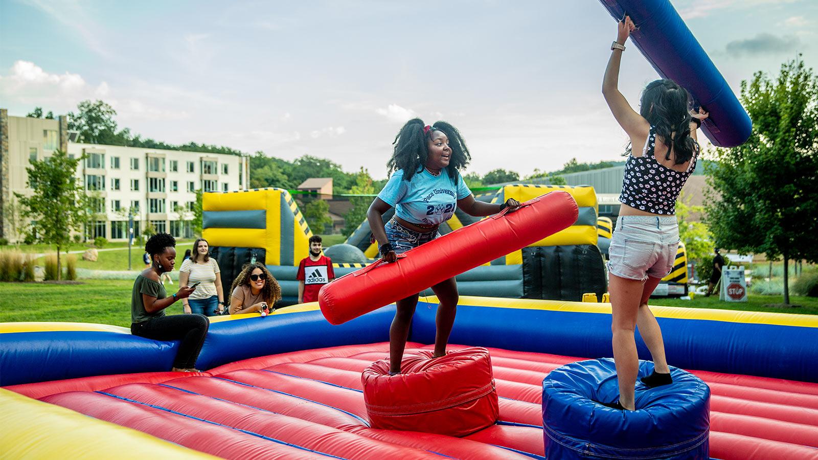 students playing on a giant inflatable bouncehouse