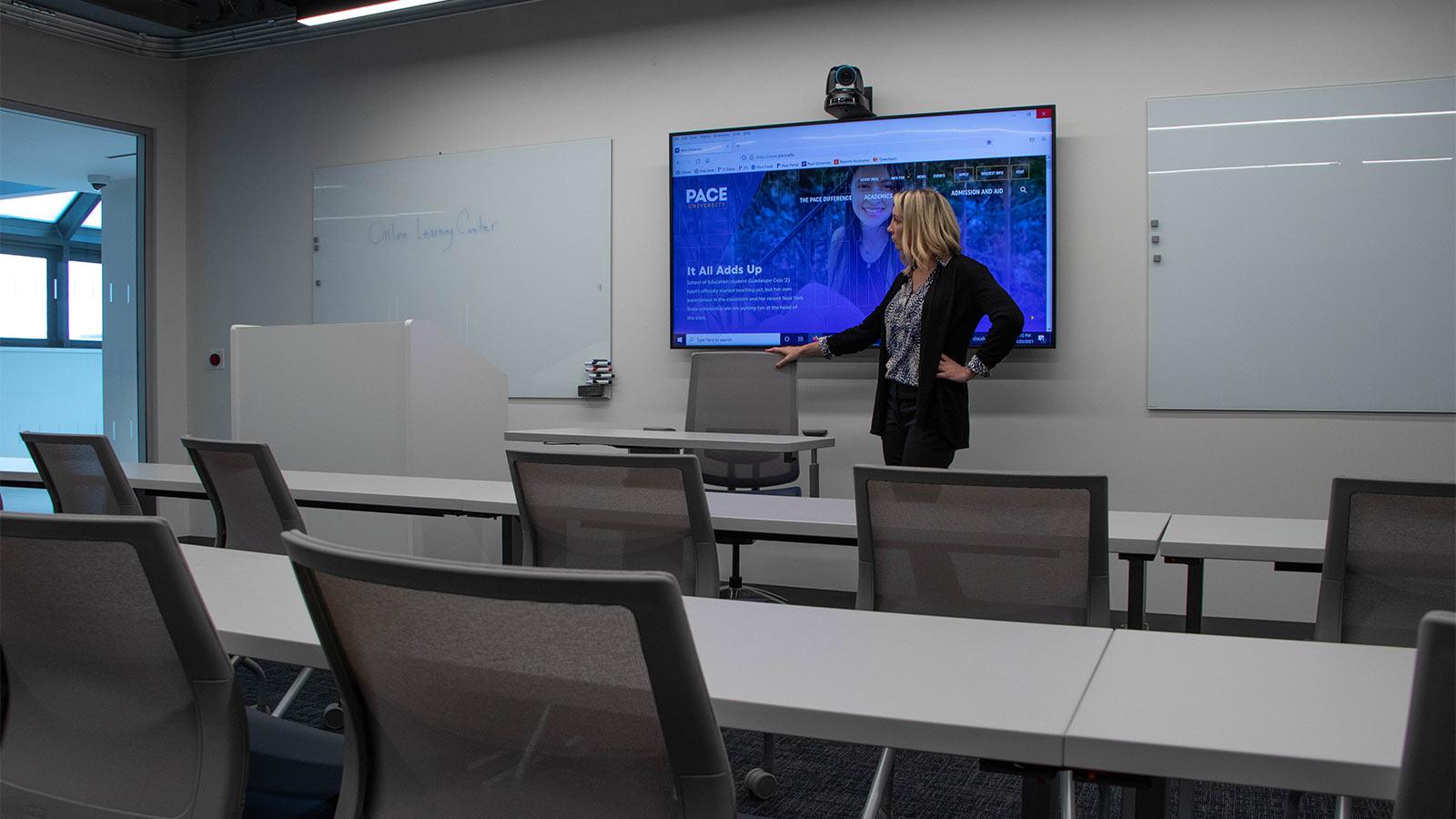 Professor in front of a flat screen tv in a classroom