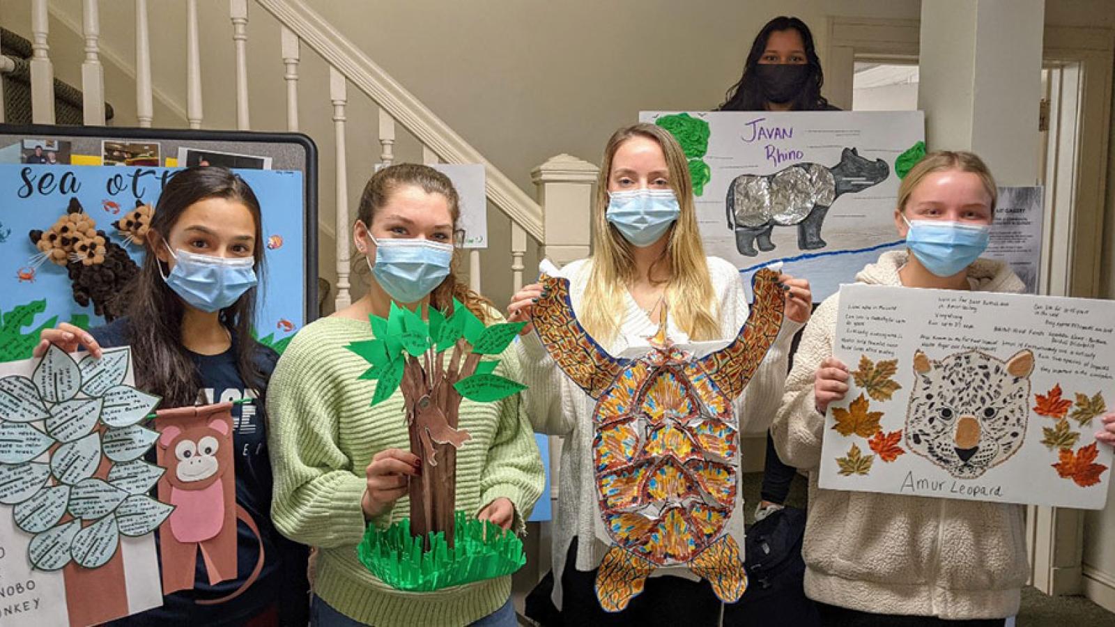 students holding posters