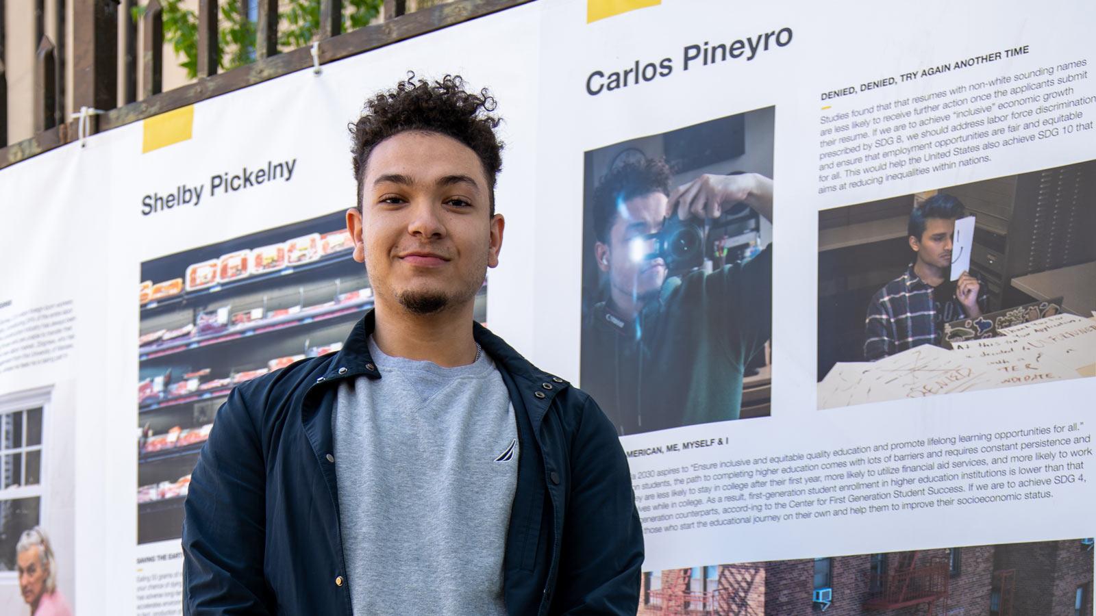 young man in front of a photo exhibit
