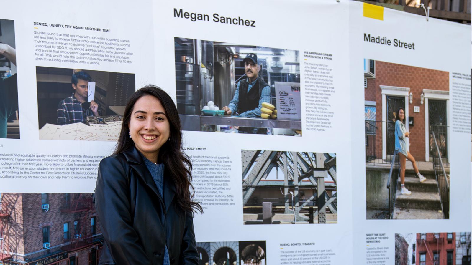 woman smiling in front of a photo exhibit