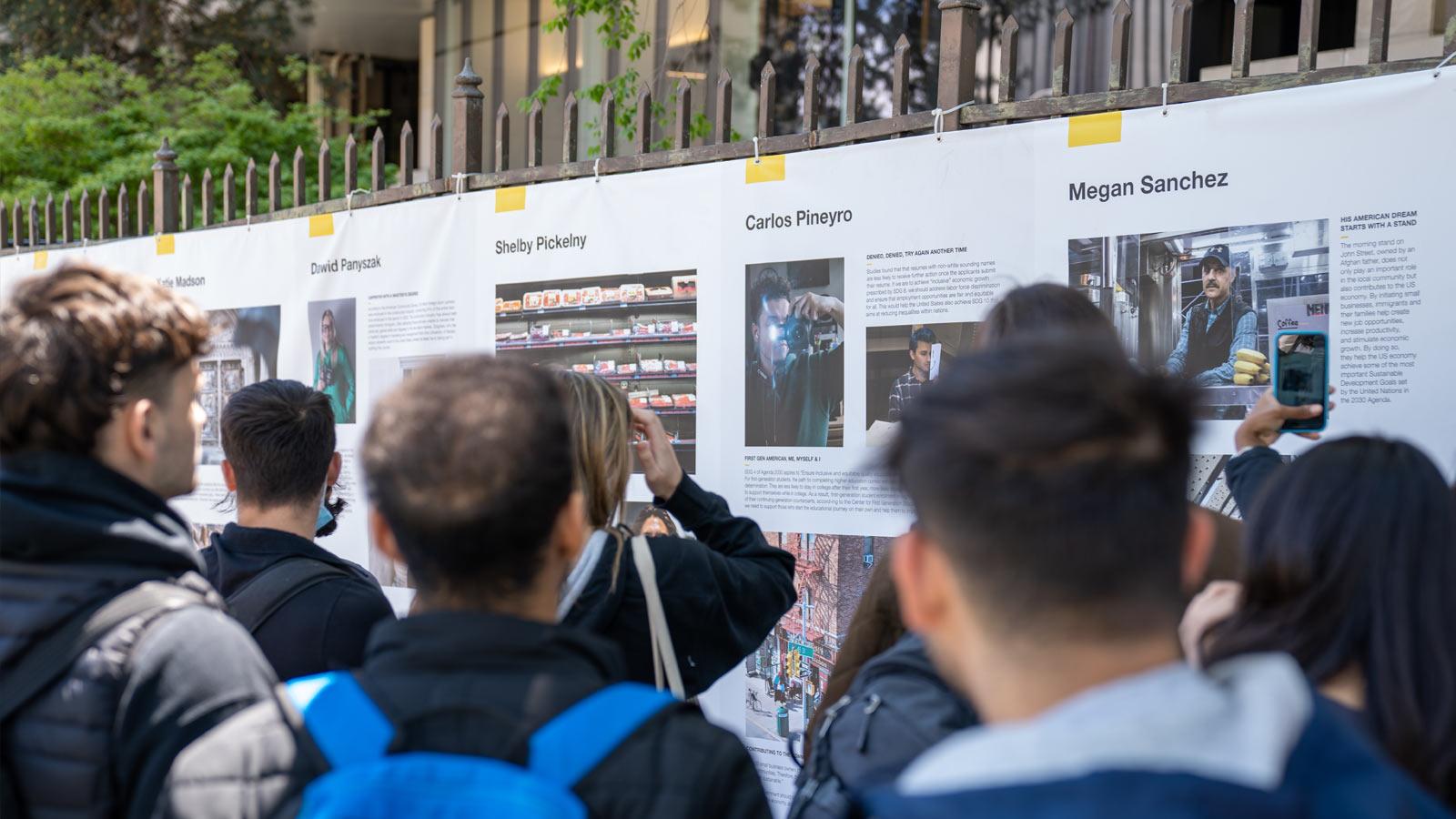 crowd looking at a photo exhibit