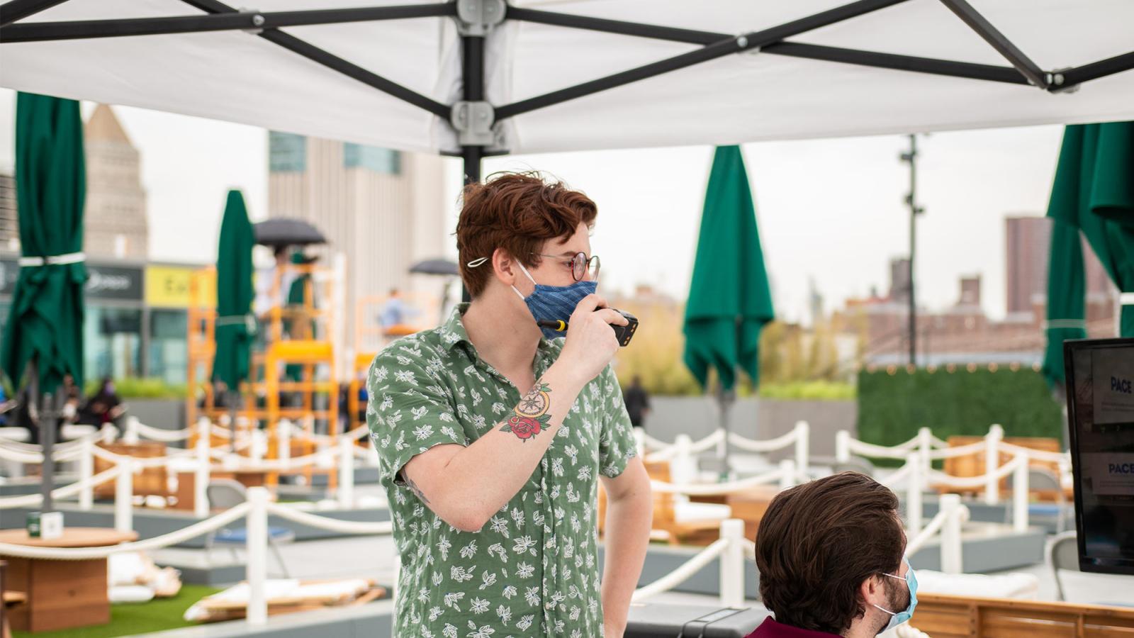 Student in mask on walkie talkie