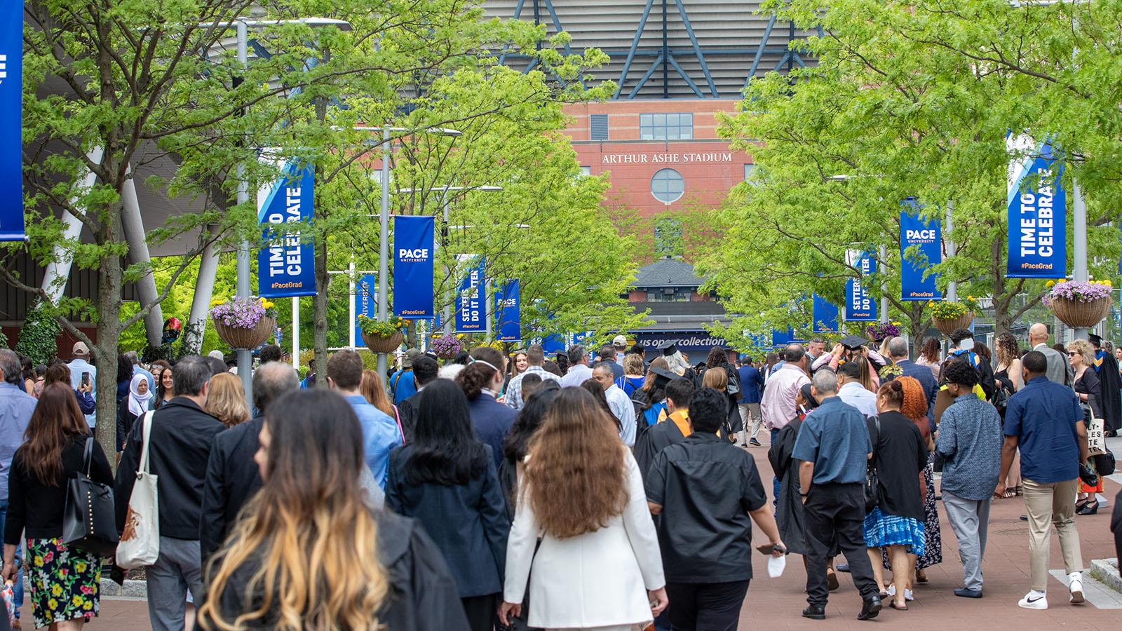 Graduates and their loved ones gathered on the plaza at the USTA Billie Jean King National Tennis Center to celebrate.  