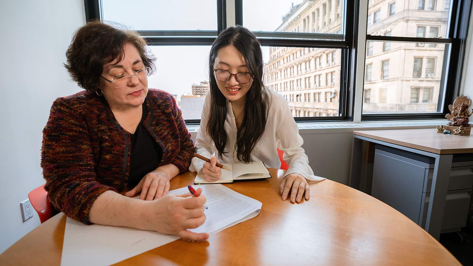 Female professor tutoring a student in a Pace University classroom