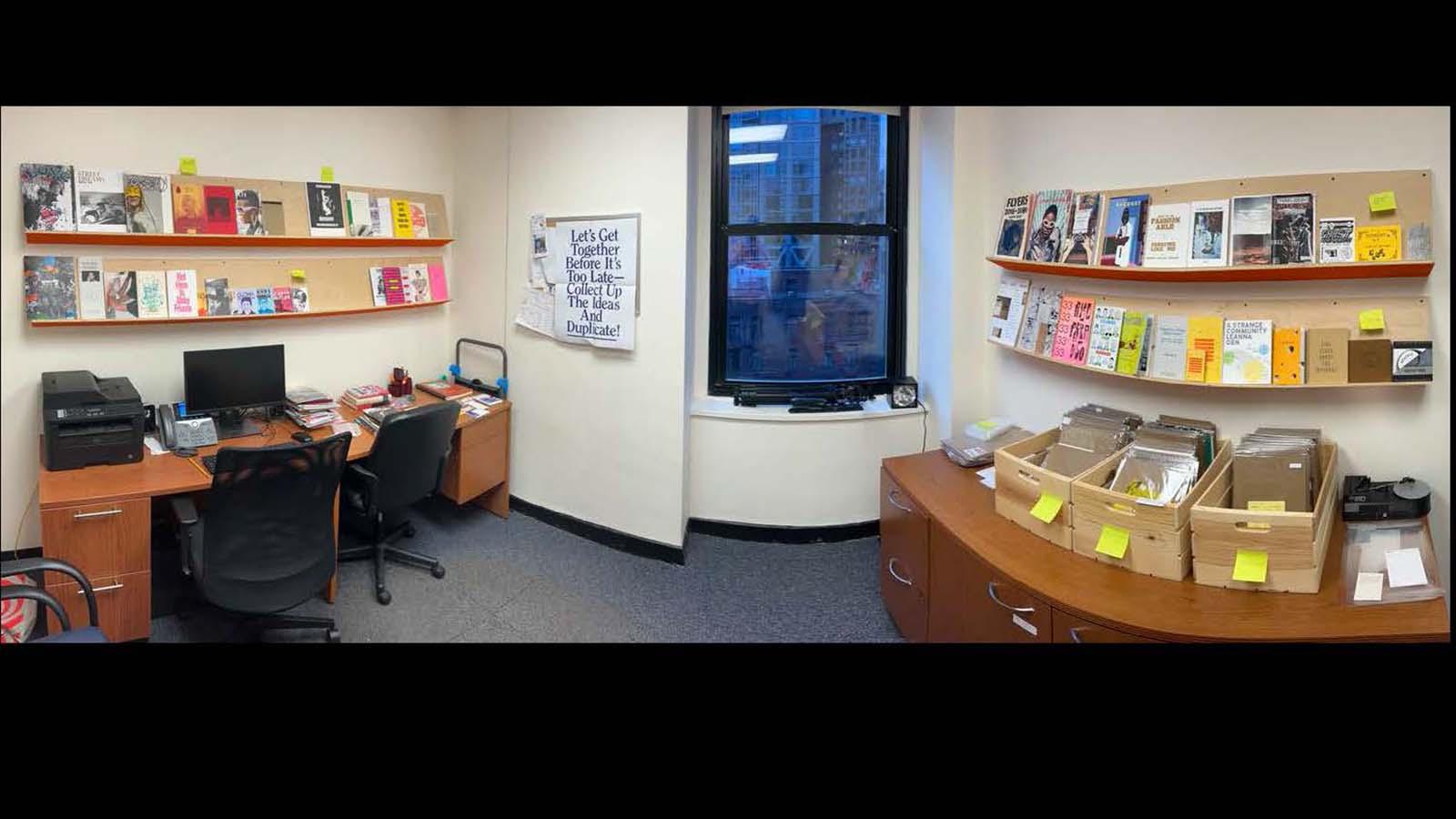 a wide angle shot of the zine library, featuring zines on shelves