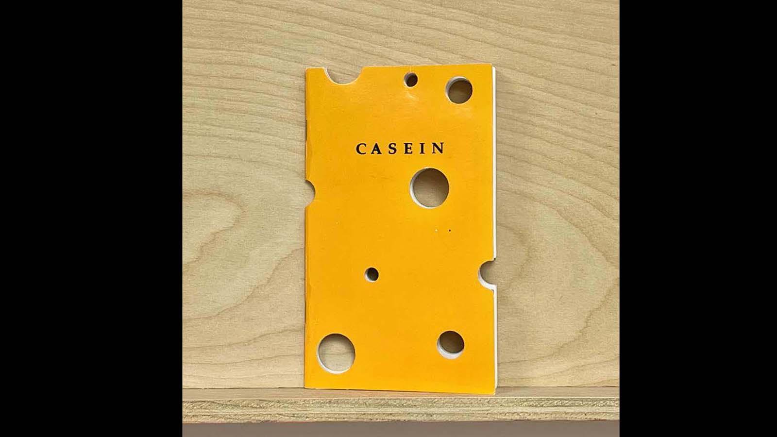 a yellow zine with holes designed to look like cheese called "Casein"