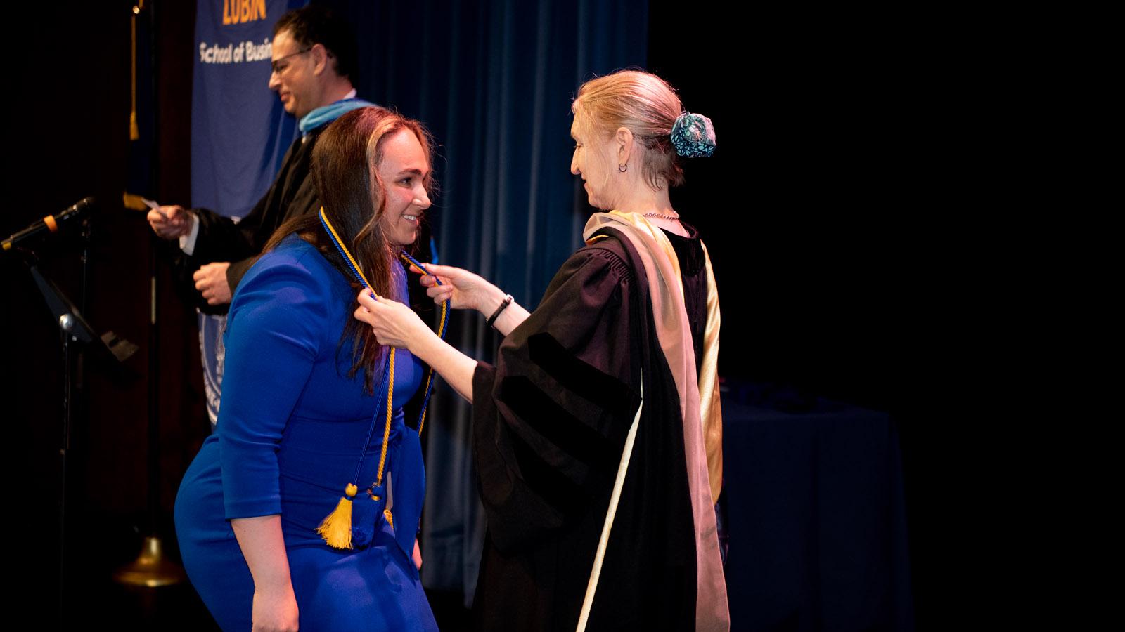 Dean Randi Priluck bestowing honor cords on the Latin honors graduates at the 2023 New York City Lubin Awards Ceremony