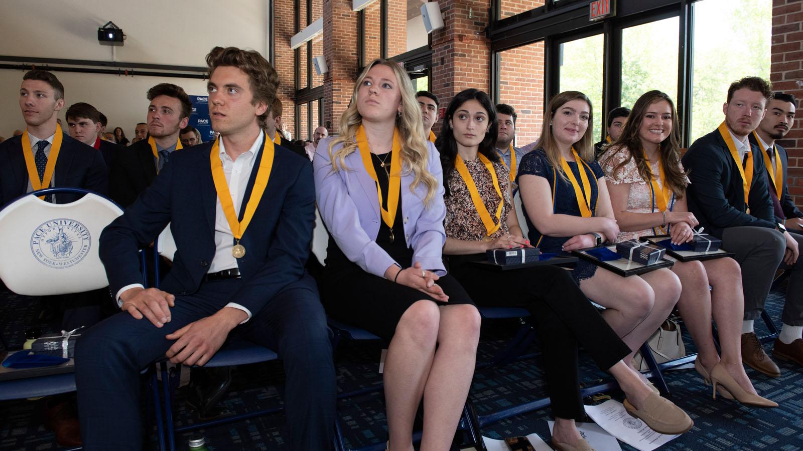 Award recipients wearing their medals while watching their classmates receive honors at the 2023 Lubin Pleasantville Awards Ceremony
