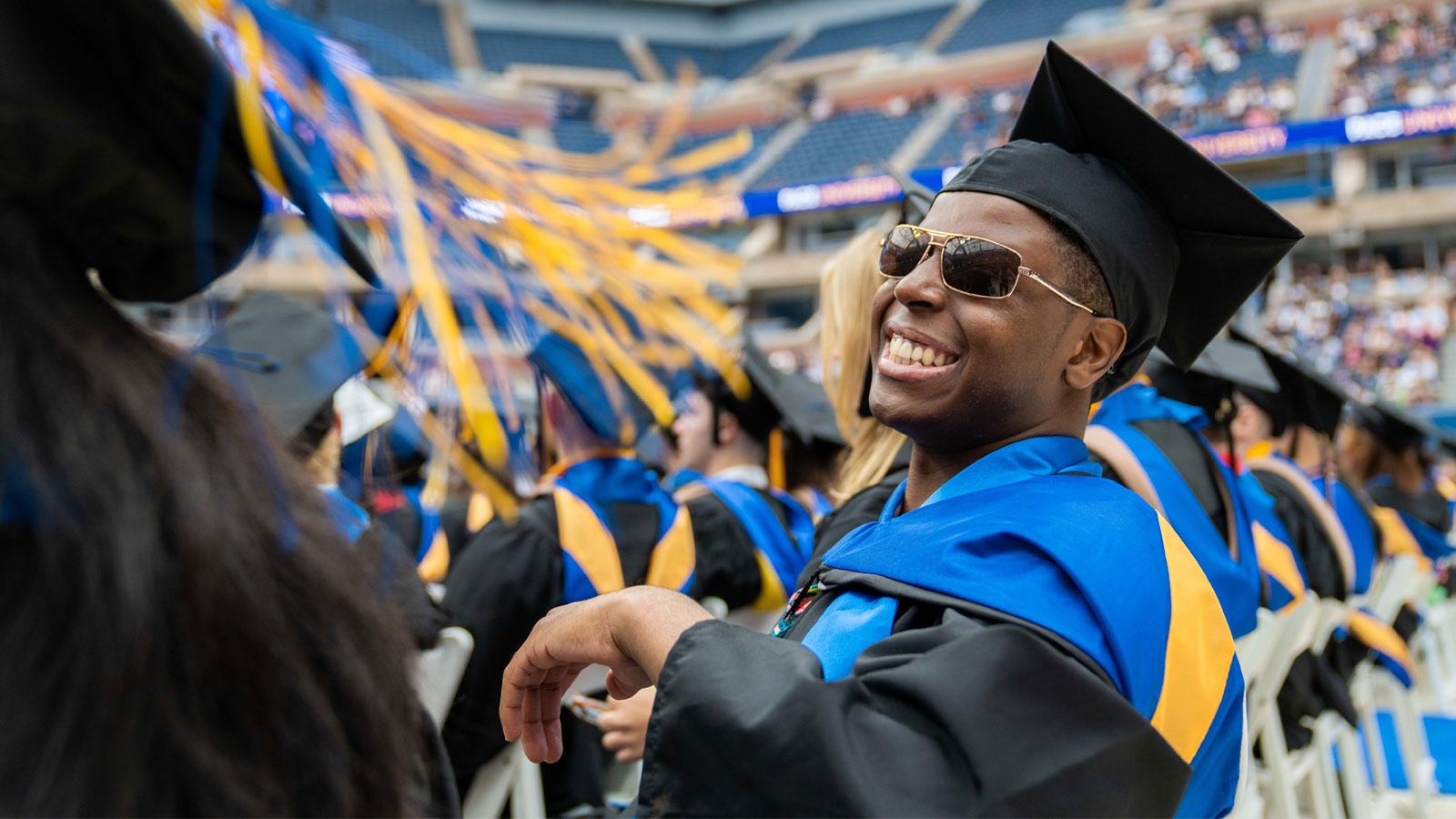 pace grad in sunglasses posing for the camera.