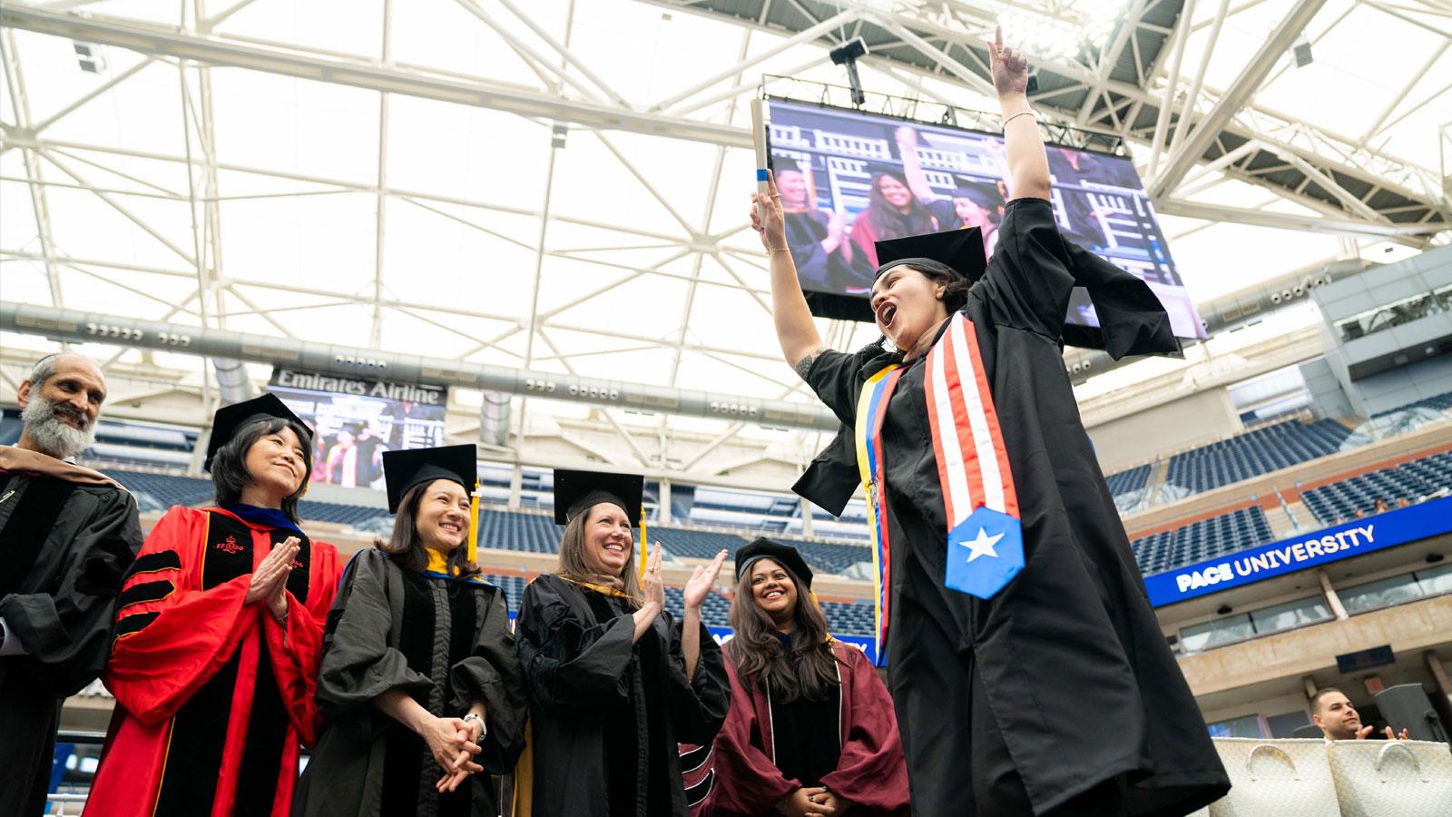 graduate crossing the stage