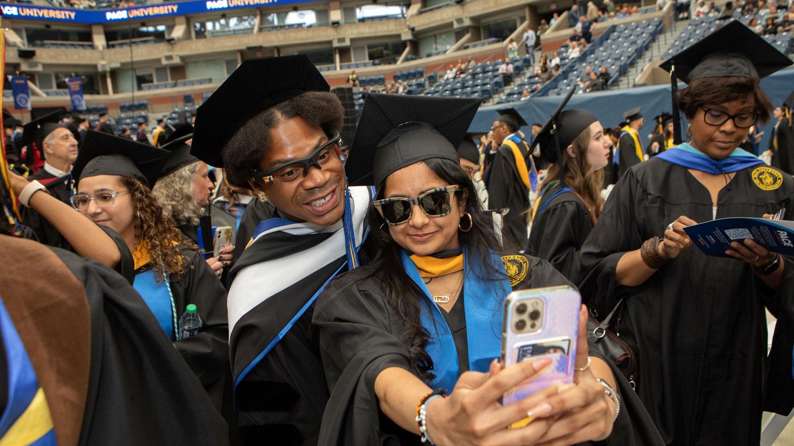 telfar clemens and a pace graduate posing for a selfie.