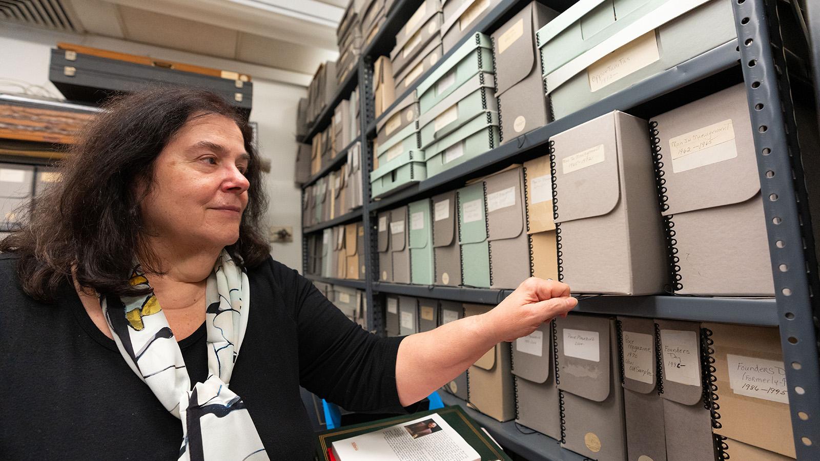 Ellen Sowchek reviews boxes in the archives
