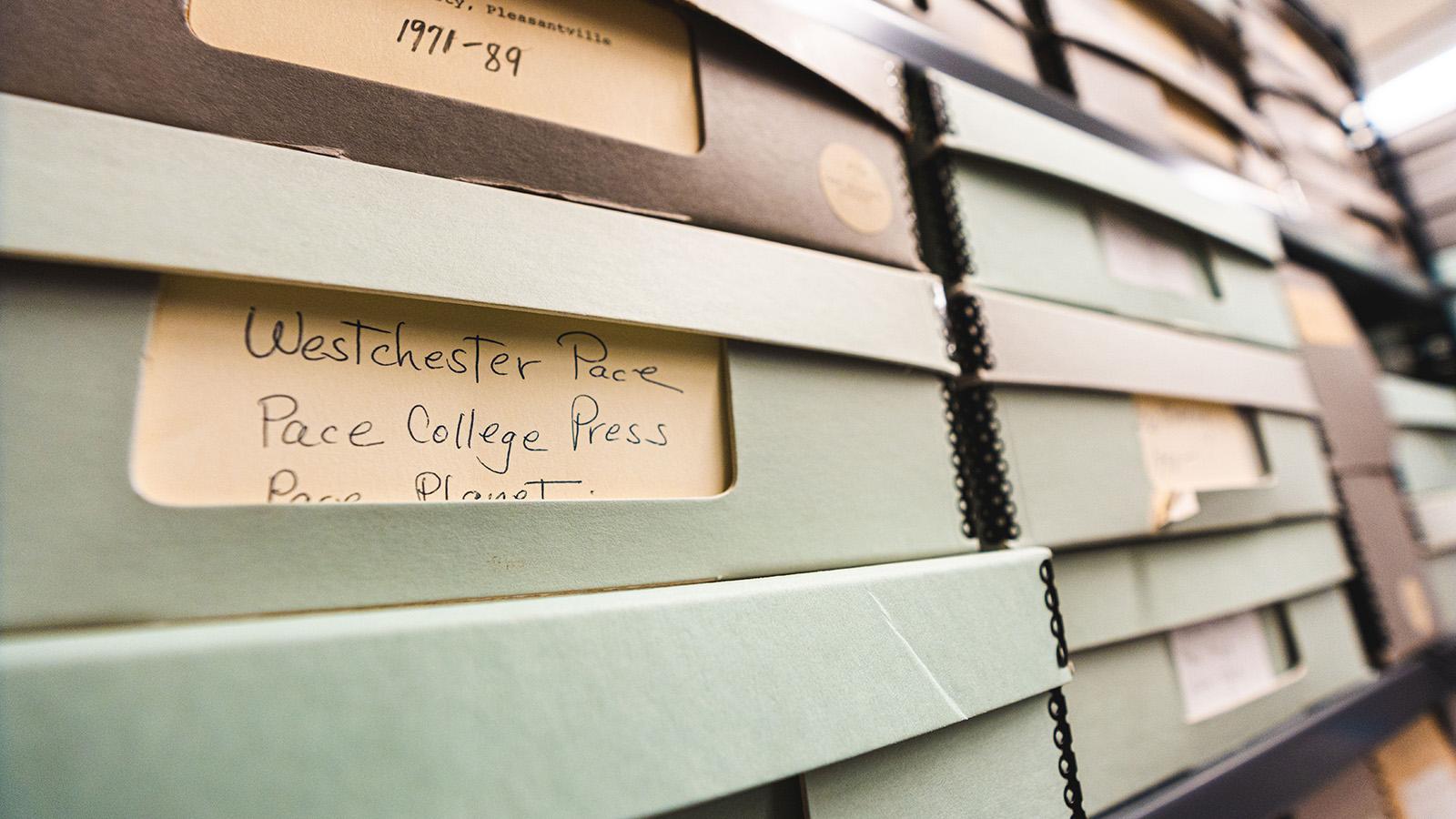 Archived boxes. A label reads "Westchester Pace. Pace College Press."